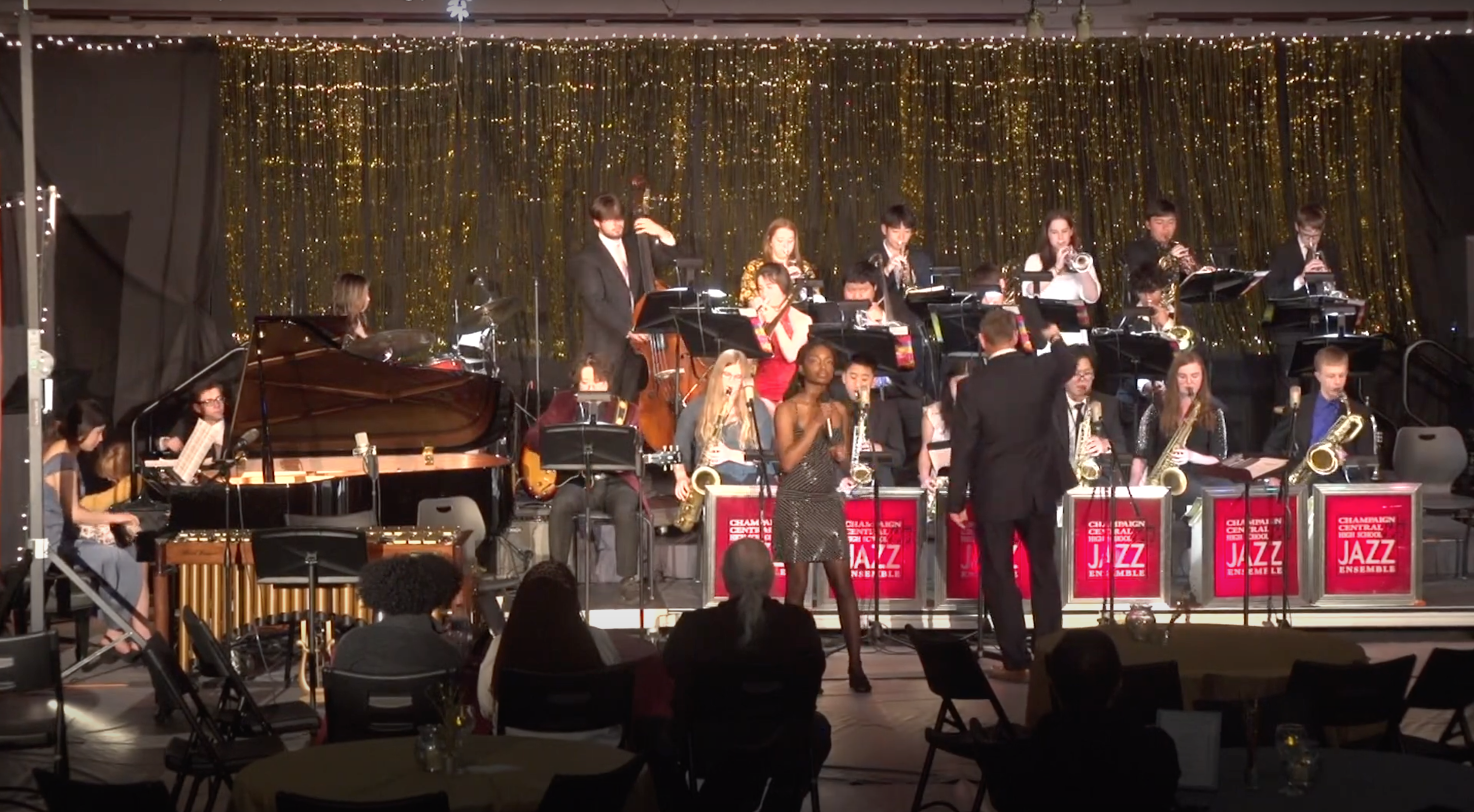 High school jazz ensemble performing on stage during a festival concert