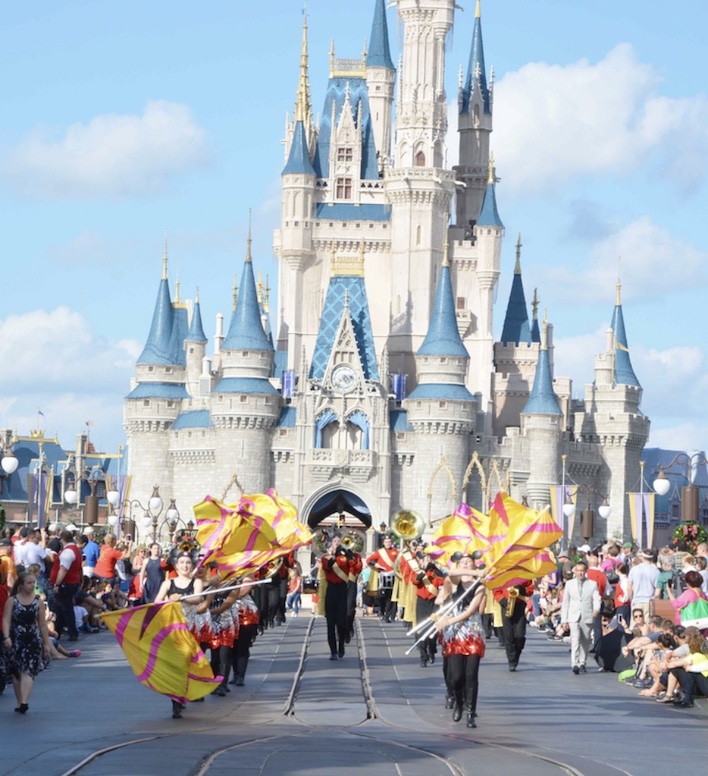 Disney Magic Kingdom castle with parade marching by in front